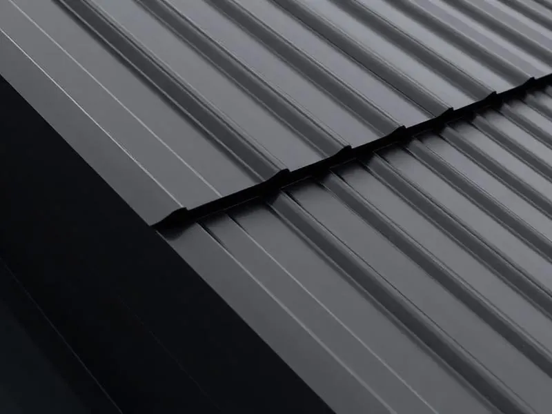 Close-up of matte black standing seam metal roof panels with raised vertical seam profile.